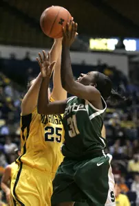Victoria Lucas-Perry - who led all players with 23 points - shoots over Michigan center Krista Phillips in the second half. (AP Photo/Paul Sancya)