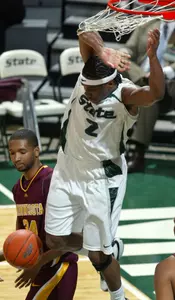 Raymar Morgan dunks over Minnesota's Damian Johnson during the first half.