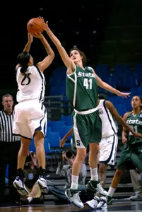 Michigan State's Allyssa DeHaan blocks a shot by Penn State's Kamela Gissendanner in the first half. (AP Photo/Steve Manuel)