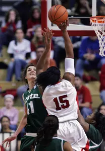 Allyssa DeHaan blocks a shot by Rutgers' Kia Vaughn in the first half.