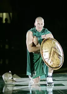 Complete with helmet, shield and sword, Drew Neitzel kneels at half court after his introduction at Madness At Munn.