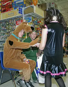 Tim Kennedy (hockey) dressed like Scooby Doo to distribute candy at the Trick or Treat event