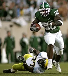 Jehuu Caulcrick leads the Big Ten and ranks third in the NCAA in scoring, averaging 10.8 points per game. His 18 rushing TDs represent the second-best single-season total in Spartan history.