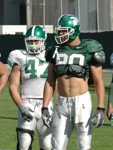 Brandon Long and Kellen Davis receive instruction during the Dec. 23 practice session at McCracken Field.