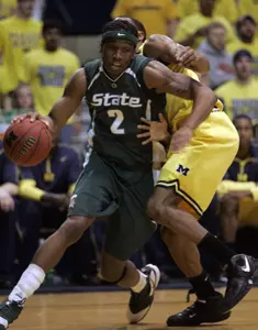 Raymar Morgan drives around Michigan forward Lester Abram during the first half. (AP Photo/Carlos Osorio)