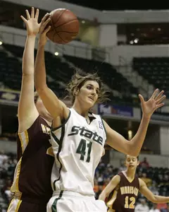 Allyssa DeHaan gets a pass in front of Minnesota center Zoe Harper in the first half.