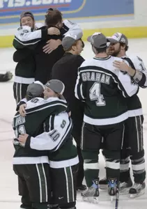 MSU players celebrate after defeating Notre Dame, 2-1, to advance to the Frozen Four