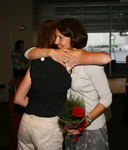 Heather Rose hugs head coach Stacy Slobodnik-Stoll during the senior cermony at the Big Ten Women's Golf Banquet on Thursday.