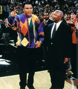 Muhammad Ali joins Clarence Underwood on the Breslin Center basketball court during the MSU-Connecticut game on Feb. 5, 2000.