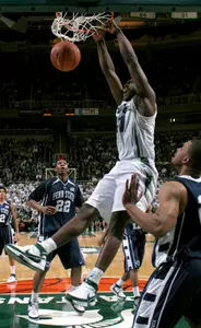 Marquise Gray dunks against Penn State's Andrew Jones (22) and Jamelle Comley during the first half Wednesday in East Lansing.