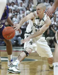 Michigan State's Drew Neitzel, right, passes the ball away from pressure by Northwestern's Sterling Williams during the first half (AP Photo)