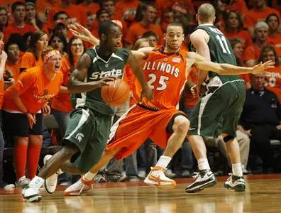 Travis Walton drives past Illinois' Calvin Brock during the Spartans' 59-51 win. (AP Photo/Daily Illini,Brad Vest)