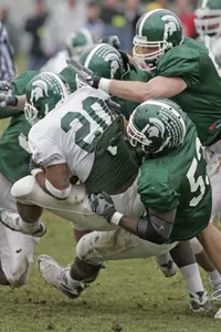 Greg Jones and Adam Decker combine to stop A.J. Jimmerson for a 1-yard gain during the second spring scrimmage.