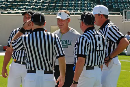 Mark Dantonio shares a laugh with the officials prior to the second preseason scrimmage.