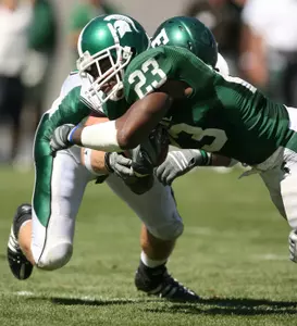Javon Ringer dives across the goal line to score a touchdown against Eastern Michigan's Ryan Downard during the second quarter. (AP Photo/Al Goldis)