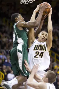 Durrell Summers looks to catch a pass over Iowa's Aaron Fuller and Matt Gatens during the first half. (AP Photo/Charlie Neibergall)