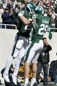 Blair White and Larry Caper celebrate after Caper's 22-yard TD run in the fourth quarter.
