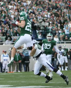 Blair White hauls in a touchdown catch against Northwestern. White posted career highs in both catches (12) and receiving yards (186) on Saturday.