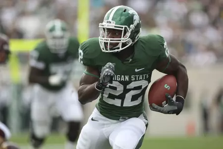 Larry Caper led the Spartans to victory over the Wolverines.