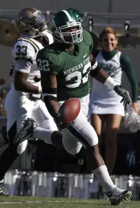 Ashton Leggett (32) scores a touchdown on a 71-yard run against Western Michigan's Mario Armstrong (33) during the first quarter. (AP Photo/Al Goldis)