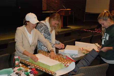 Spartan student-athlets wrap gifts on Sunday at the Smith Center.