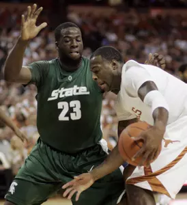 Texas forward Damion James attempts to move around Draymond Green during the first half.
