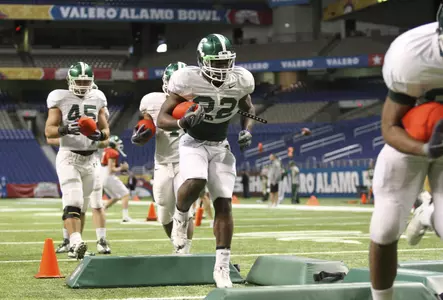 Larry Caper goes through a footwork drill during Tuesday's practice at the Alamo Dome in San Antonio. Matthew Mitchell/MSU Athletic Communications