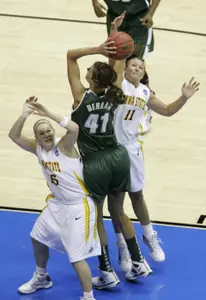Allyssa DeHaan shoots between Iowa State guards Heather Ezell, left, and Kelsey Bolte, right, in the first half.