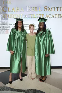 Lauren Aitch (left) and Aisha Jefferson (right) pose with head coach Suzy Merchant prior to Commencement on Friday.