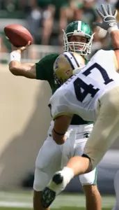 Quarterback Kirk Cousins passes against pressure from Montanta State's Dane Fletcher (47) during the first quarter in East Lansing.