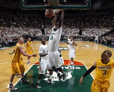 Michigan State's Draymond Green (23) dunks against Minnesota's Colton Iverson, left, and Justin Cobbs (3) during the first half of an NCAA college basketball game, Wednesday, Jan. 13, 2010, in East Lansing, Mich. (AP Photo/Al Goldis)