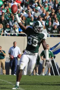 Trenton Robinson celebrates after recording an interception in the fourth quarter during MSU's 26-6 win over Illinois.
