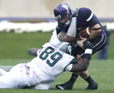 Colin Neely(89) and Jerel Worthy sack Northwestern quarterback Dan Persa. (AP)