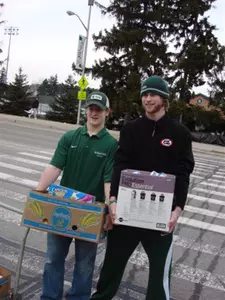 Torey Krug and Trevor Nill help load food during the 2009 Food Drive