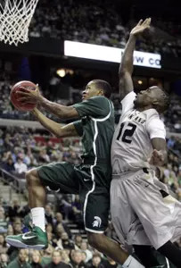 Michigan State guard Keith Appling goes to the basket past Oakland guard Ledrick Eackles.