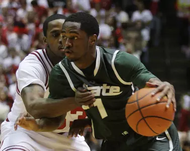 Michigan State guard Kalin Lucas, right, drives to the basket against Indiana guard Devan Dumes during the first half of an NCAA college basketball game in Bloomington, Ind., Tuesday, Feb. 16, 2010. (AP Photo/Darron Cummings)