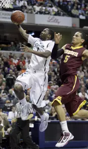 Michigan State's Kalin Lucas (1) goes up for a basket against Minnesota's Devoe Joseph (5) in the first half of an NCAA college basketball game in the quarterfinals of the Big Ten conference tournament in Indianapolis, Friday, March 12, 2010.(AP Photo/Darron Cummings)