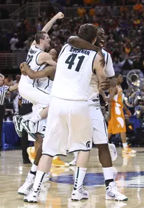 The Spartans celebrate following their victory over Tennessee in the Midwest Regional Final.