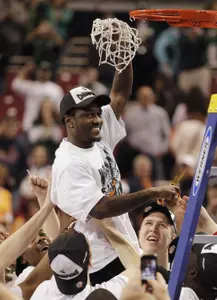 Kalin Lucas smiles after his teammates lifted him up to cut down the net following MSU's win over Tennessee.