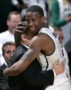 Raymar Morgan hugs Coach Izzo after leaving the court for the final time in Michigan State's win over Michigan.