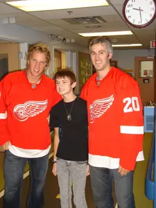 Justin Abdelkader (L) and Drew Miller with Michigan's Champion Child Landon Whitaker