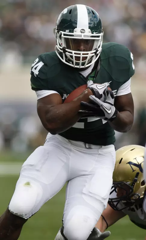 Michigan State's Le'Veon Bell scores a touchdown. (AP Photo/Al Goldis)