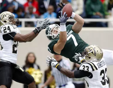 Michigan State's Keith Nichol (7) catches a pass in the end zone for a touchdown between Western Michigan's Lewis Toler (24) and Mario Armstrong (33) during the second quarter of an NCAA college football game, Saturday, Sept. 4, 2010, in East Lansing, Mich. (AP Photo/Al Goldis)