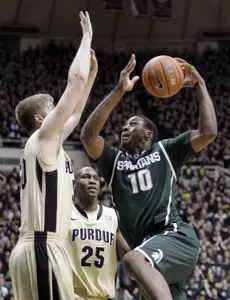 Michigan State forward Delvon Roe, right, looses the ball as he shoots over Purdue forward Travis Carroll in the first half.
