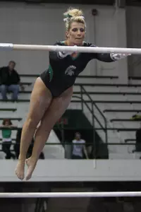 Jackie Berg captured her first individual event title when she won the uneven bars with a score of 9.875.