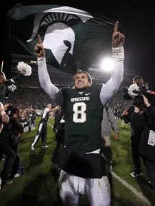 Kirk Cousins celebrates following MSU's 37-31 win over Wisconsin Saturday.