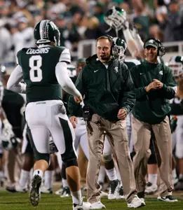 Dantonio greets Kirk Cousins on the sideline following a Spartan touchdown in last Saturday's win over Wisconsin.