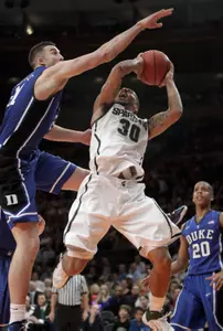 Duke forward Miles Plumlee tries to prevent a shot by Michigan State guard Brandon Wood. (AP Photo/Kathy Willens)
