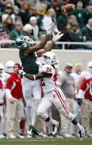 Michigan State's B.J. Cunningham (3) pulls in a 37-yard pass against Indiana's Kenny Mullen (22) during the first quarter. (AP Images)
