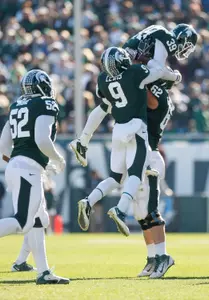 Following his third-quarter interception, Trenton Robinson is congratulated by Isaiah Lewis and Chris McDonald.